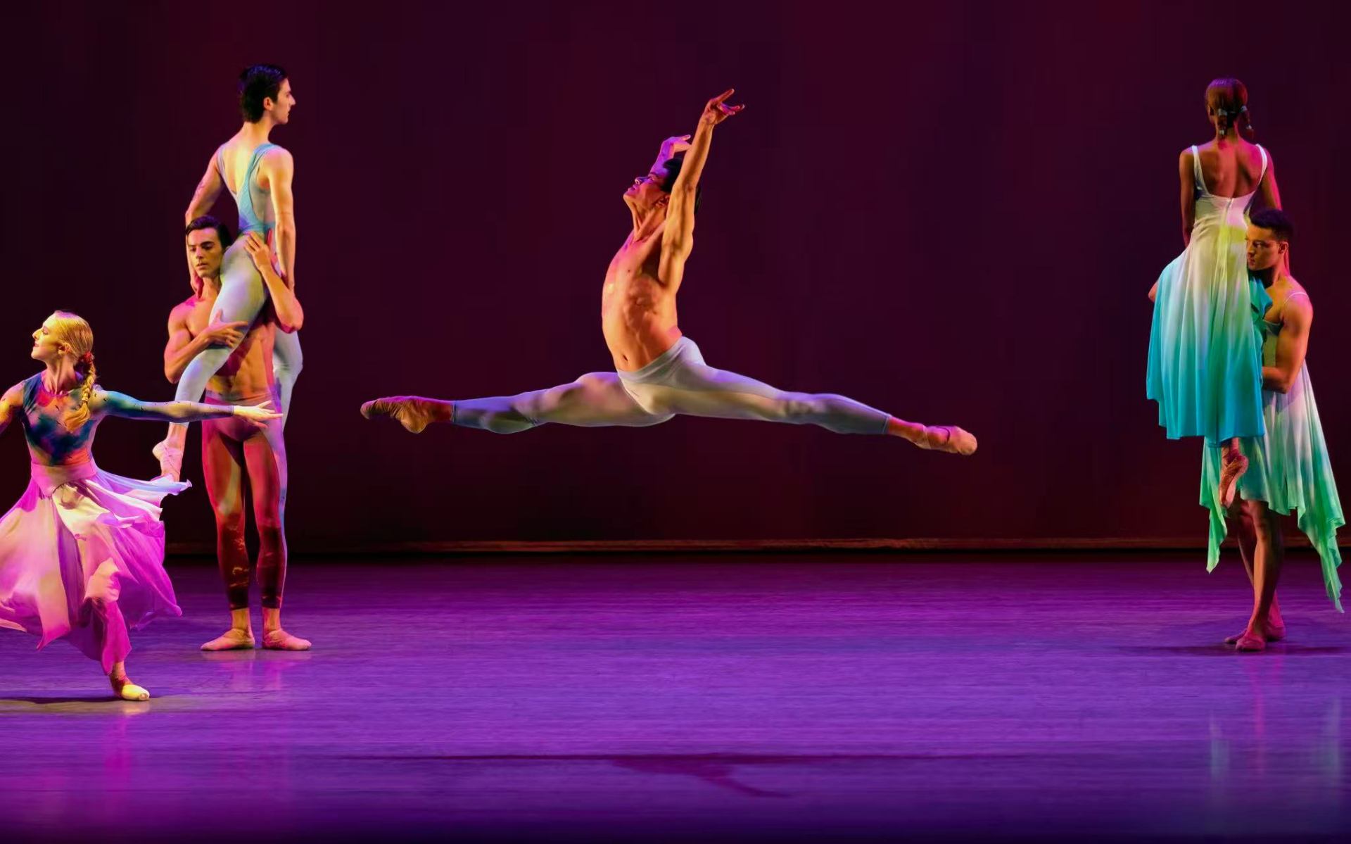 sky to hold series — sky to hold — soaring grand jeté beneath saturated magenta light
