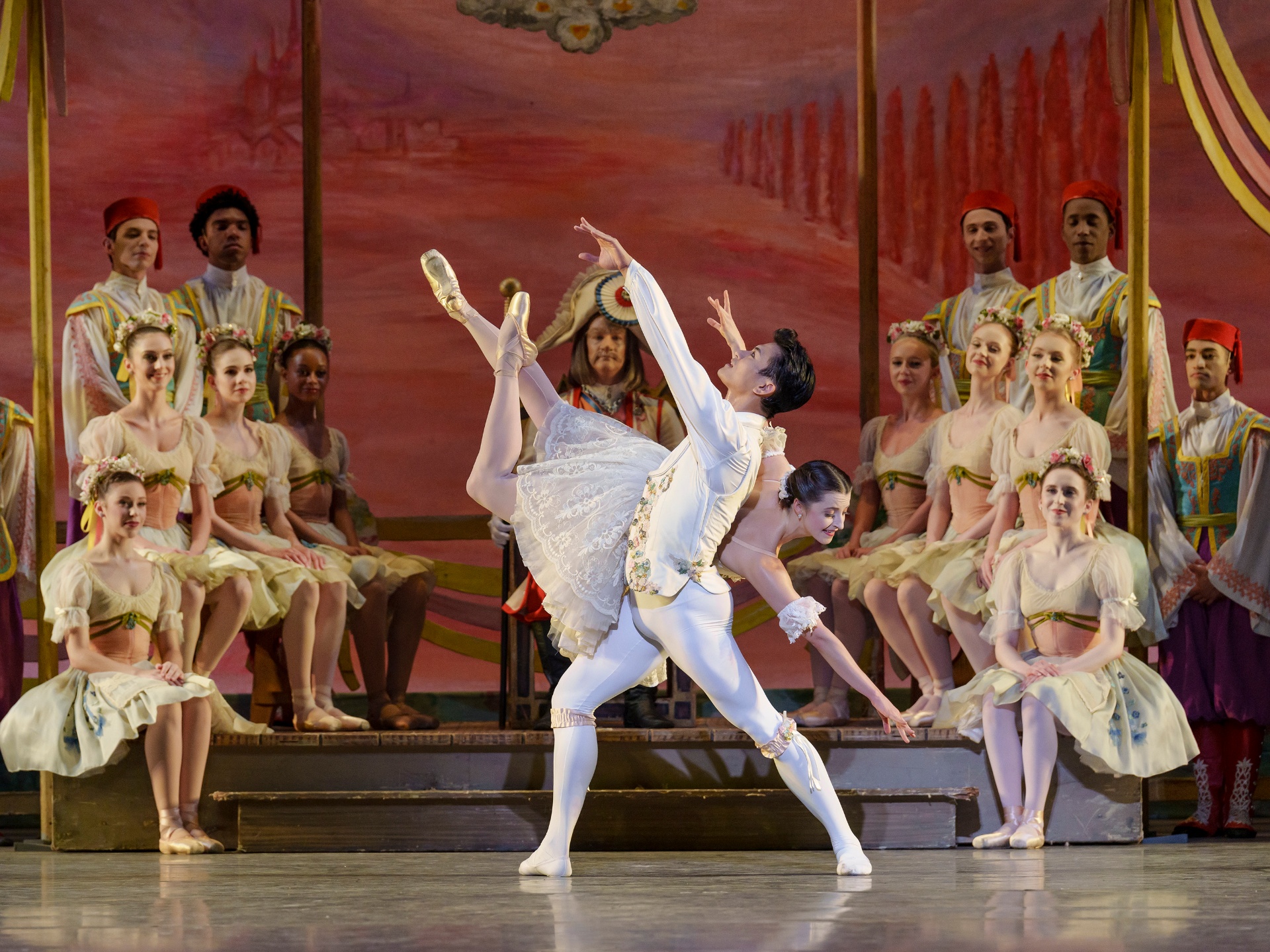 Coppélia series — Coppélia — Act III pas de deux with Swanilda in white tutu in penché supported by Frantz before the village court
